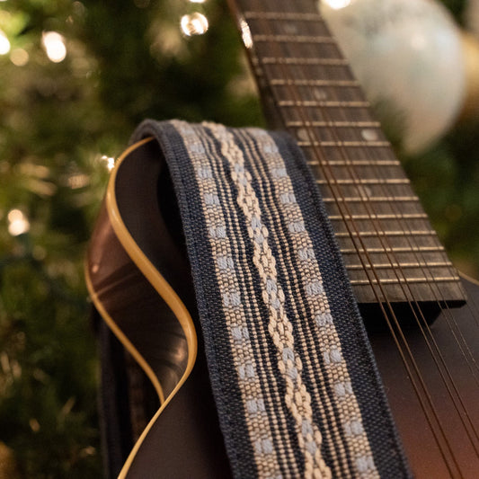 The best gifts for guitar players — a handwoven Maya guitar strap on an acoustic guitar