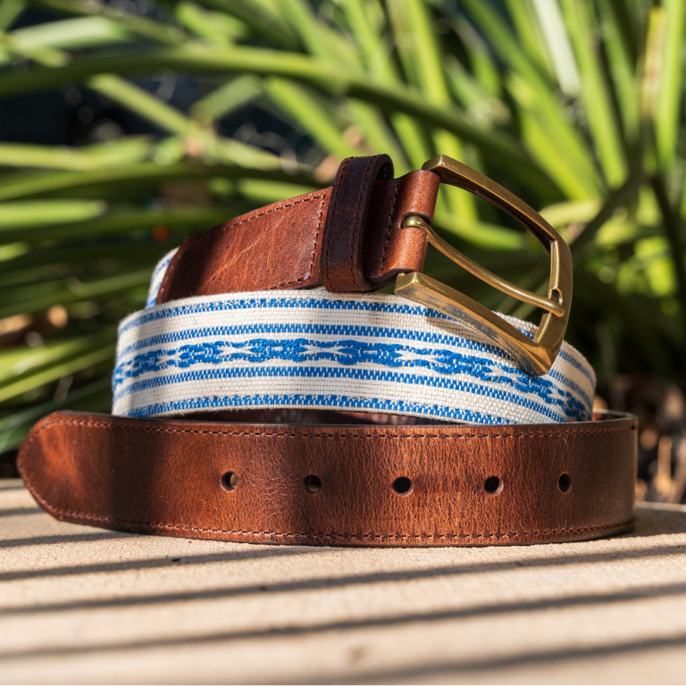 Hand-loomed blue belt with brass buckle, featuring intricate Guatemalan patterns and craftsmanship by Antigua Threads artisans