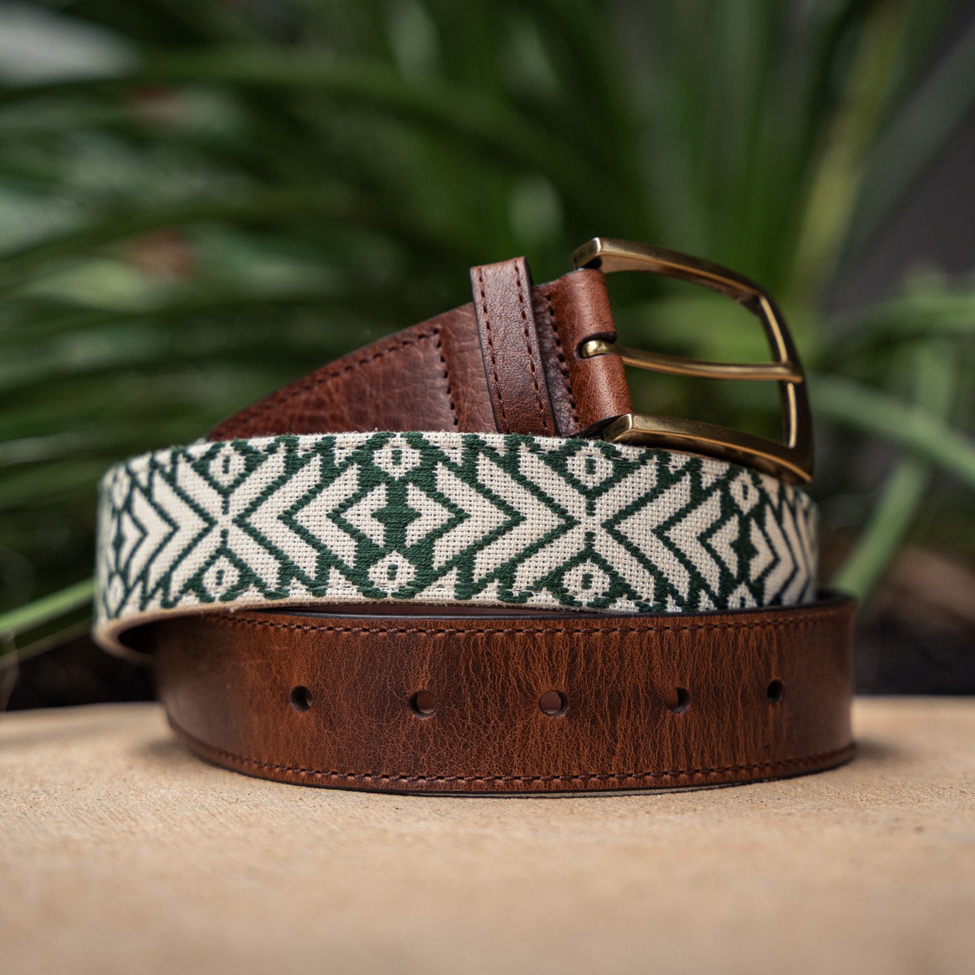 Tikal handwoven Maya belt — forest green and cream geometric diamond pattern with full-grain leather ends and antique brass buckle